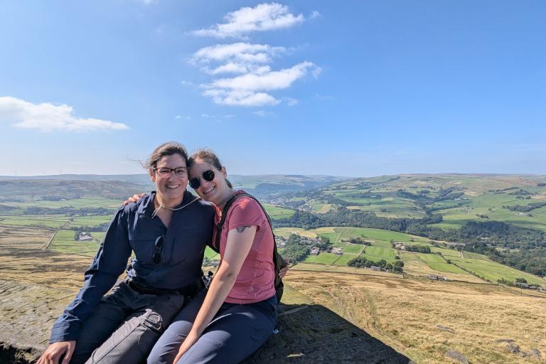 Anny and J posing for a photo in the countryside.