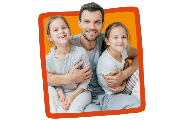 A male foster carer poses for a photo with two foster children.