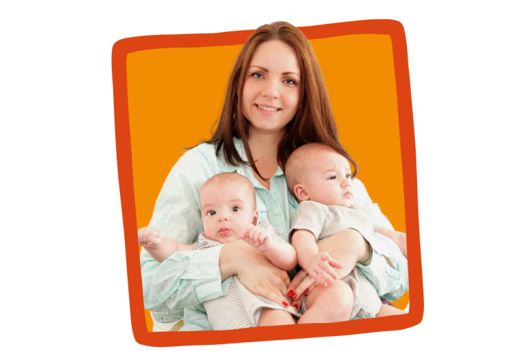 A foster carer poses for a photo with two young babies.